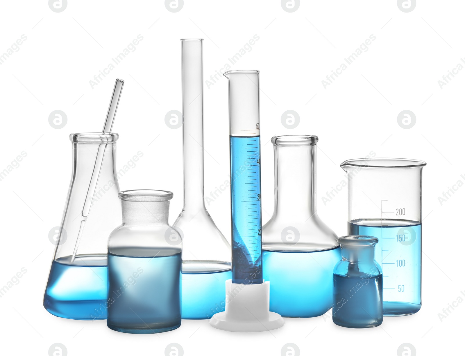 Photo of Different laboratory glassware with light blue liquid isolated on white