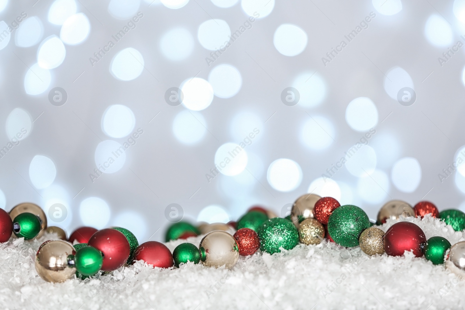 Photo of Christmas decoration on snow against blurred background