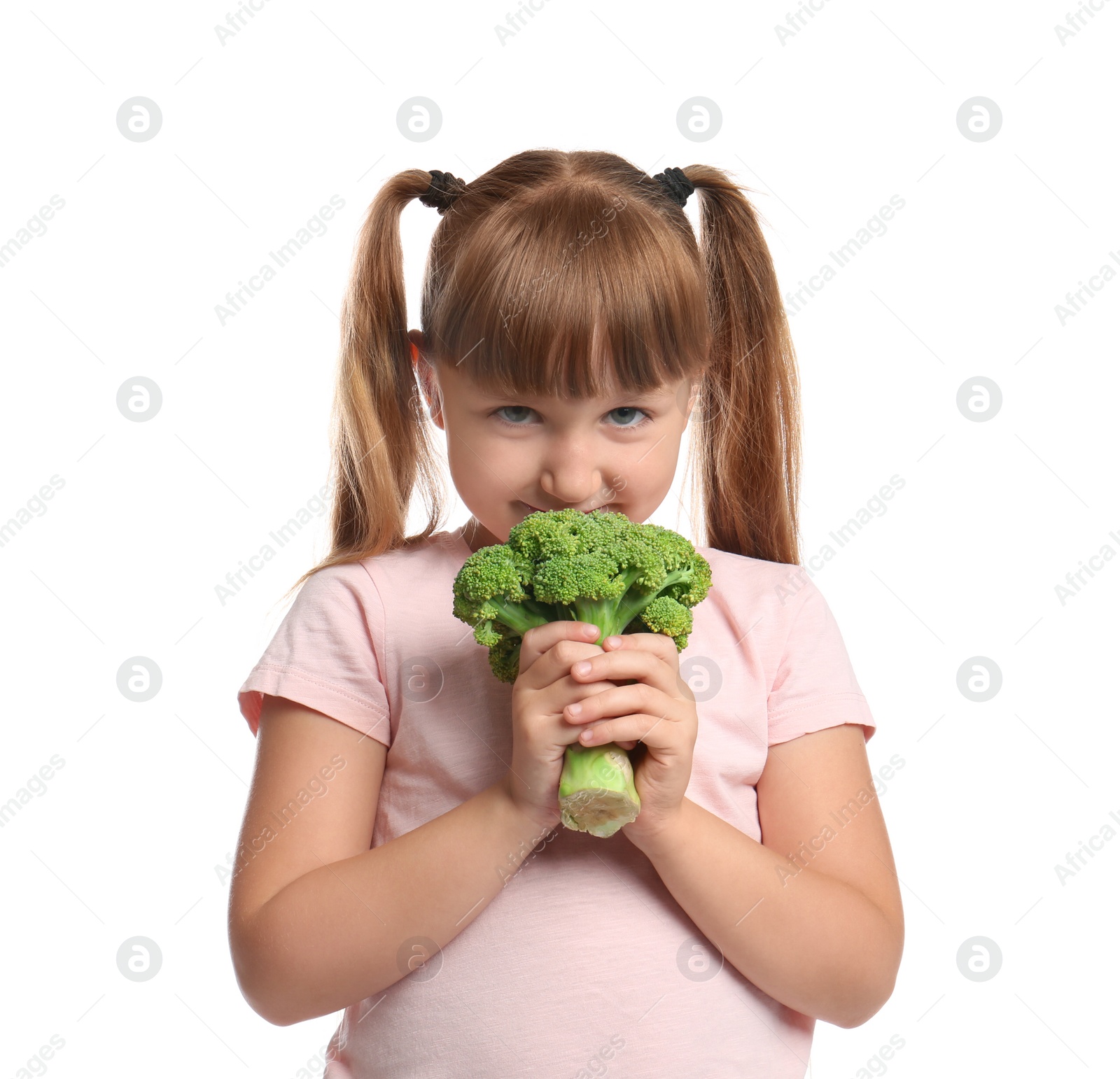 Photo of Portrait of cute little girl with broccoli on white background