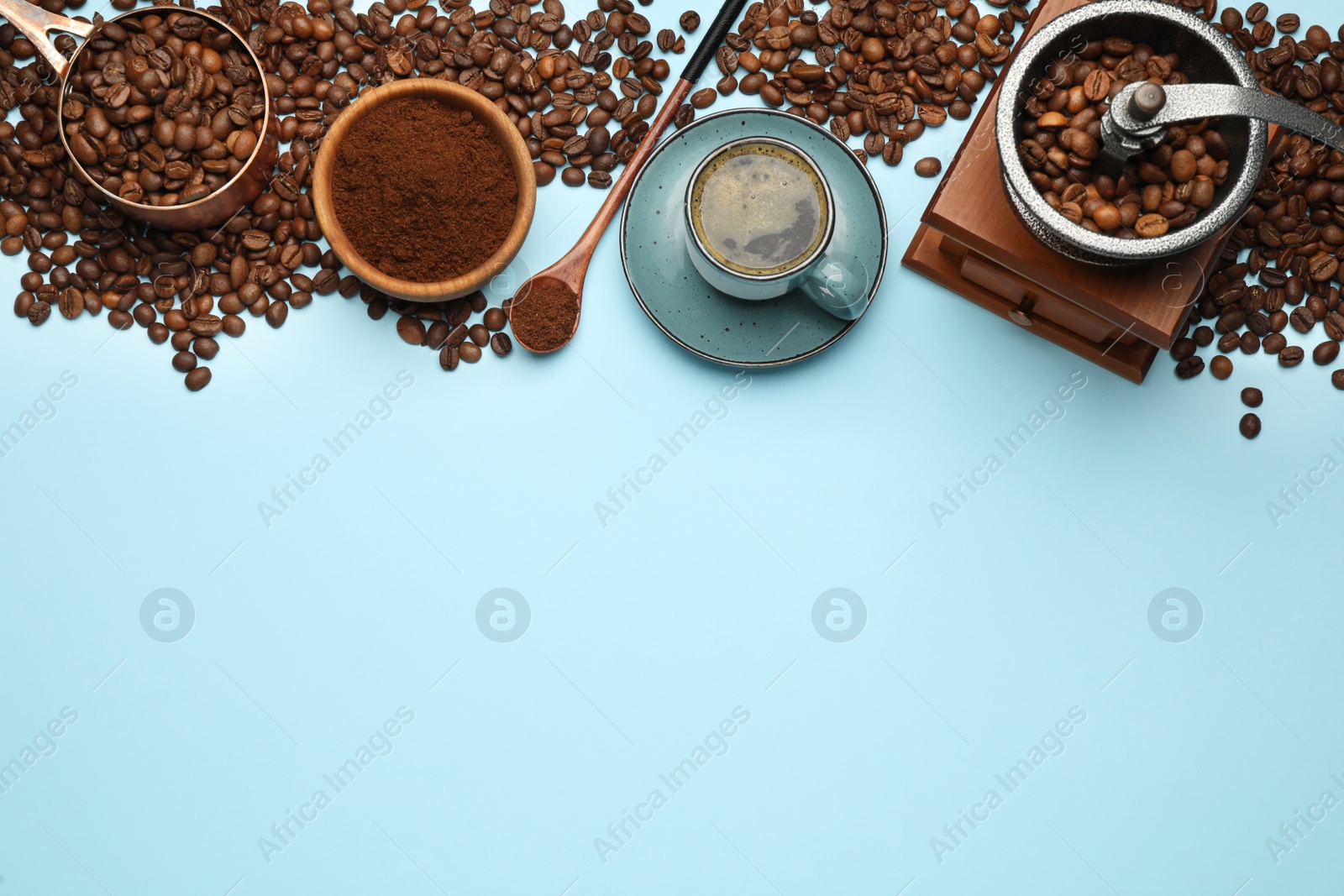 Photo of Flat lay composition with ground coffee and roasted beans on light blue background, space for text