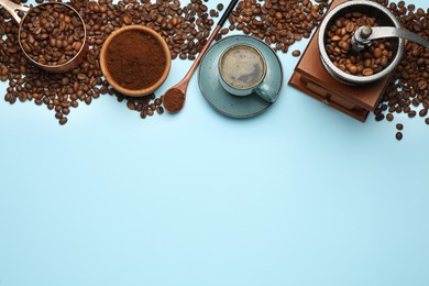 Flat lay composition with ground coffee and roasted beans on light blue background, space for text