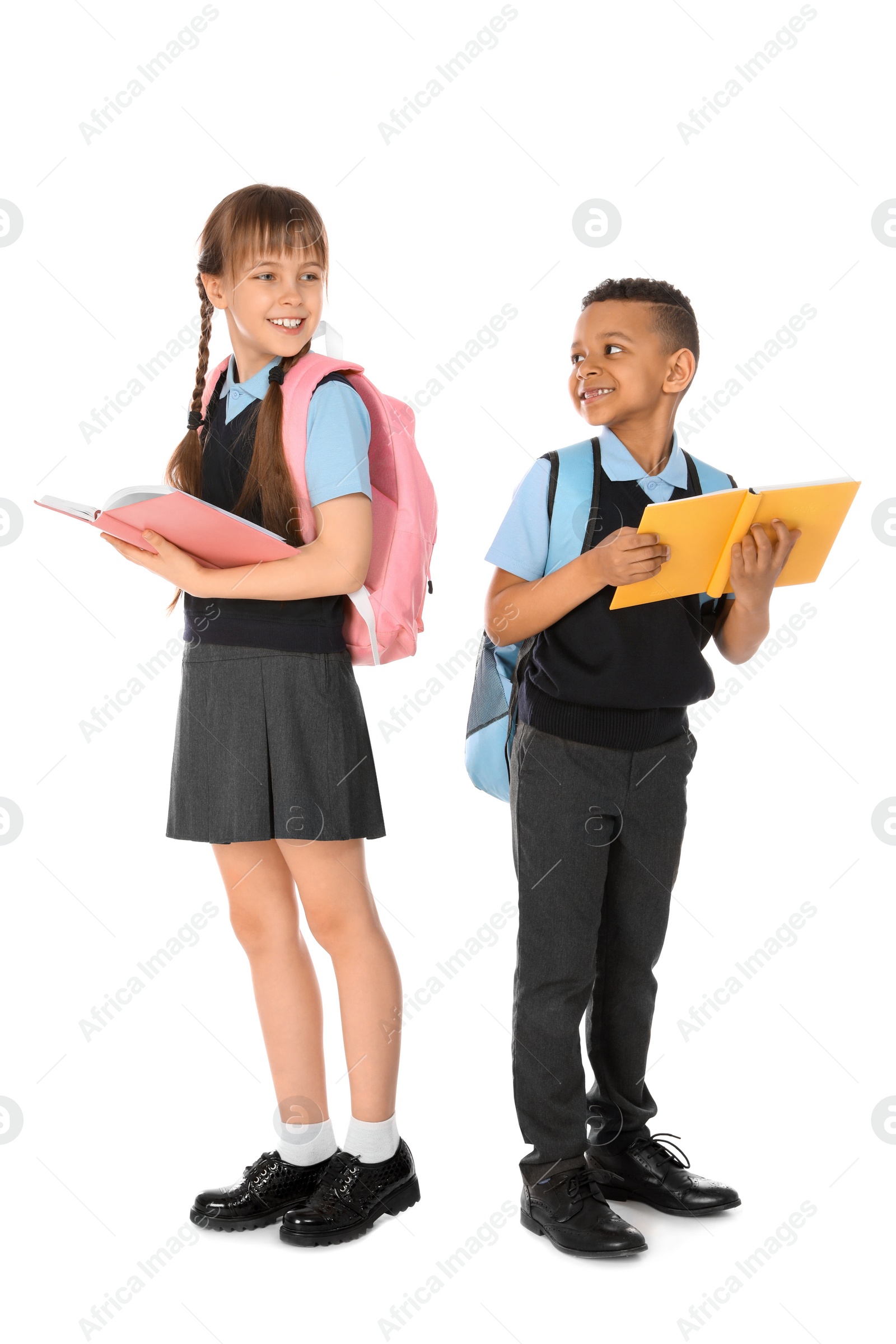 Photo of Full length portrait of cute children in school uniform on white background