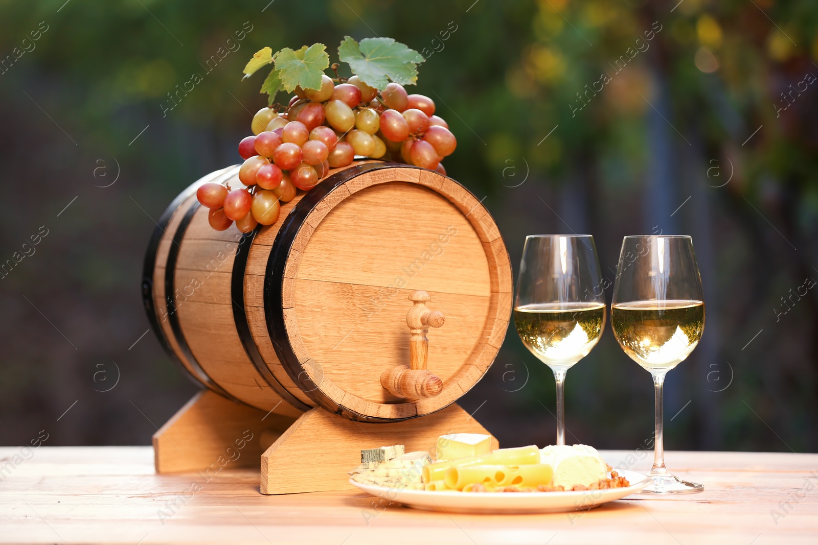 Photo of Composition with wine and snacks on table outdoors