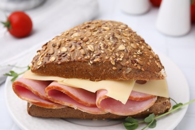 Photo of Delicious sandwich with ham and cheese on plate, closeup