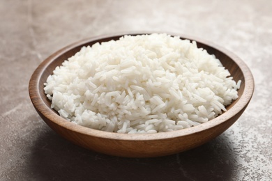 Photo of Plate of tasty cooked white rice on table, closeup