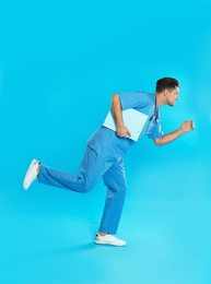 Photo of Doctor with clipboard running on blue background