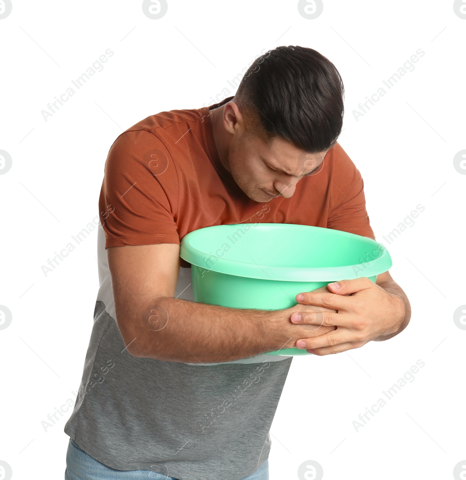 Photo of Man with basin suffering from nausea on white background. Food poisoning