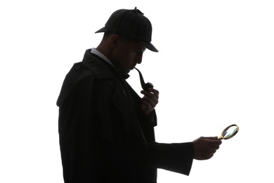 Photo of Old fashioned detective with smoking pipe and magnifying glass on white background