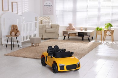 Photo of Yellow car in room at home. Child's toy