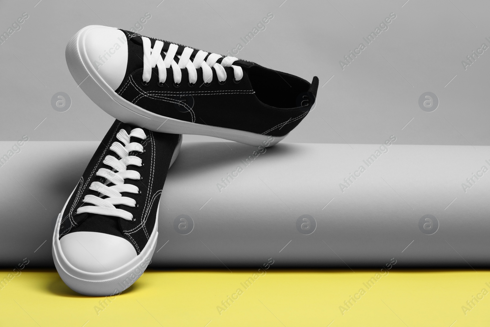 Photo of Pair of stylish sneakers on color background, space for text