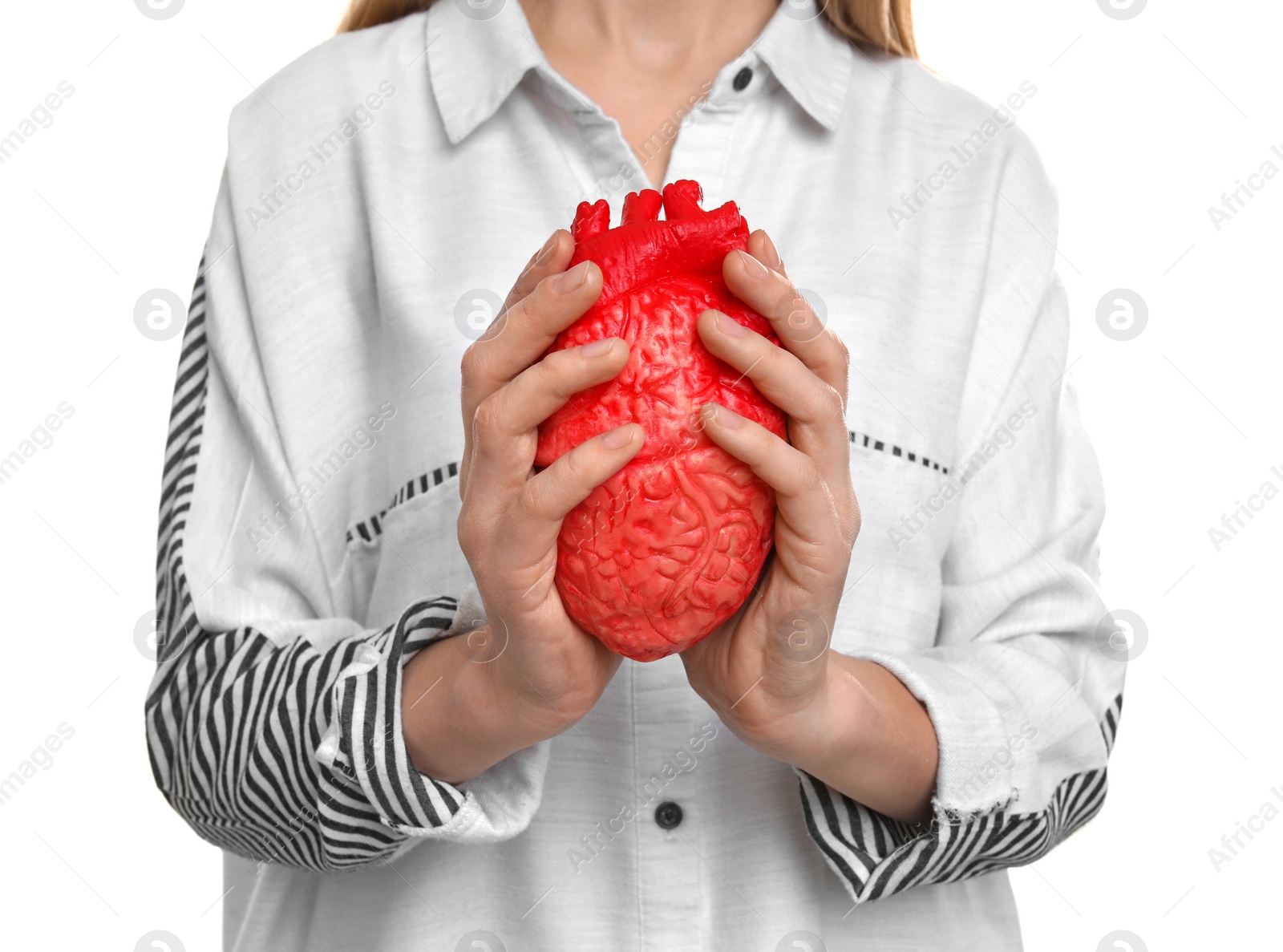 Photo of Woman holding model of heart on white background. Heart attack concept