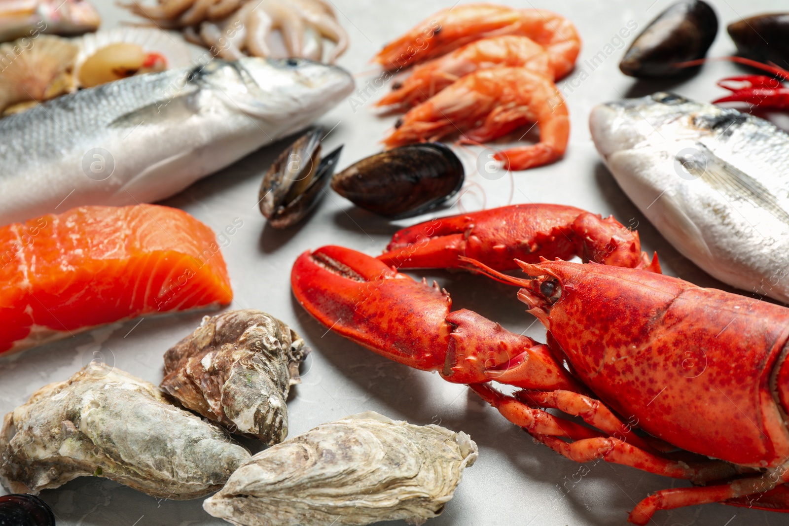 Photo of Fresh fish and seafood on marble table