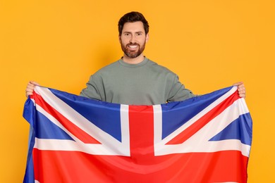 Man with flag of United Kingdom on yellow background