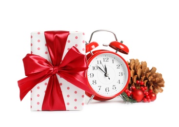 Photo of Beautifully wrapped gift box, alarm clock and decorations on white background