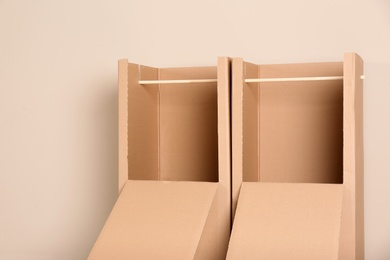 Photo of Empty cardboard wardrobe boxes on color background