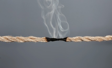 Photo of Rope burnt to breaking point on dark background