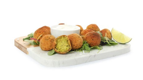 Photo of Delicious falafel balls with herbs, lime and sauce on white background