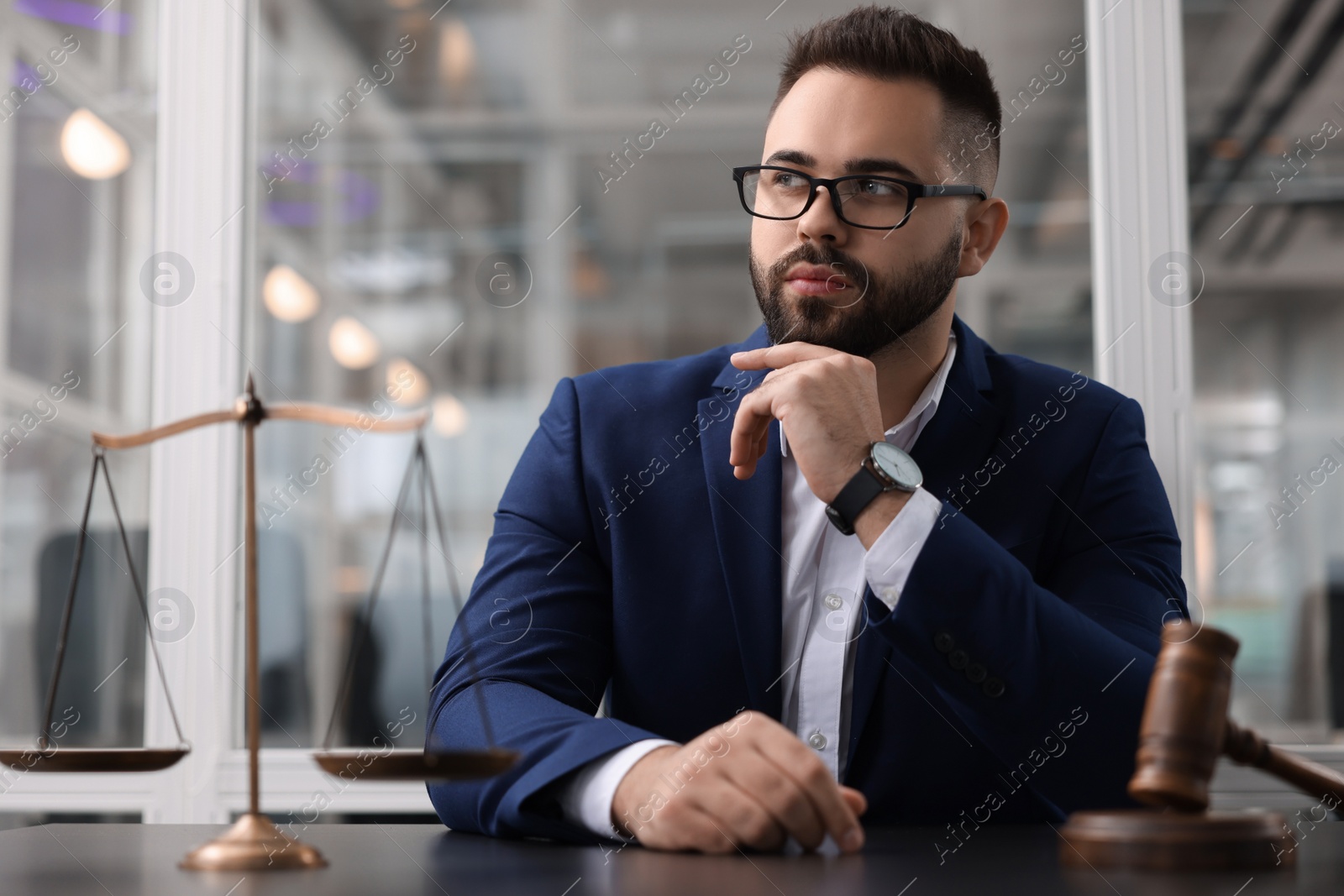 Photo of Portrait of handsome lawyer at table in office