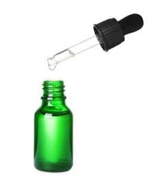 Photo of Bottle and pipette with essential oil on white background