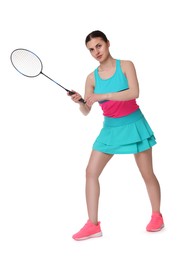 Young woman playing badminton with racket on white background
