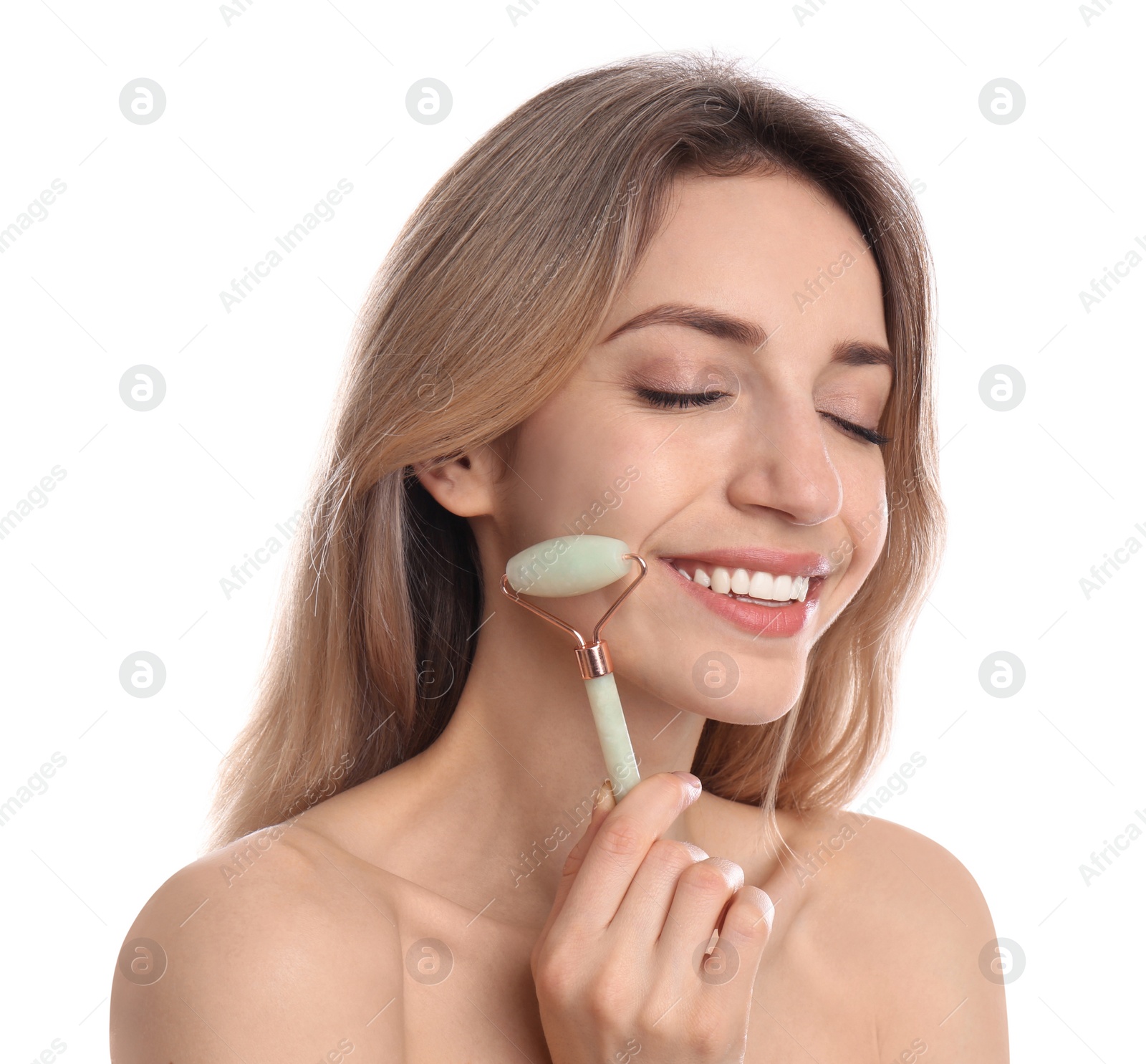 Photo of Young woman using natural jade face roller on white background