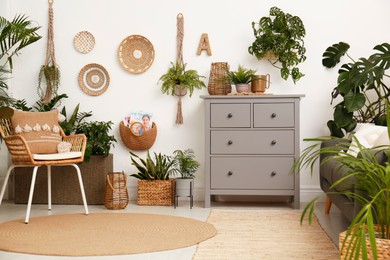 Living room interior with stylish furniture and green plants