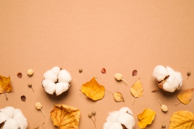 Flat lay composition with autumn leaves on beige background, space for text