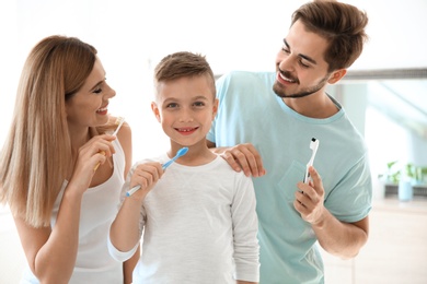 Photo of Happy family with toothbrushes in bathroom. Personal hygiene