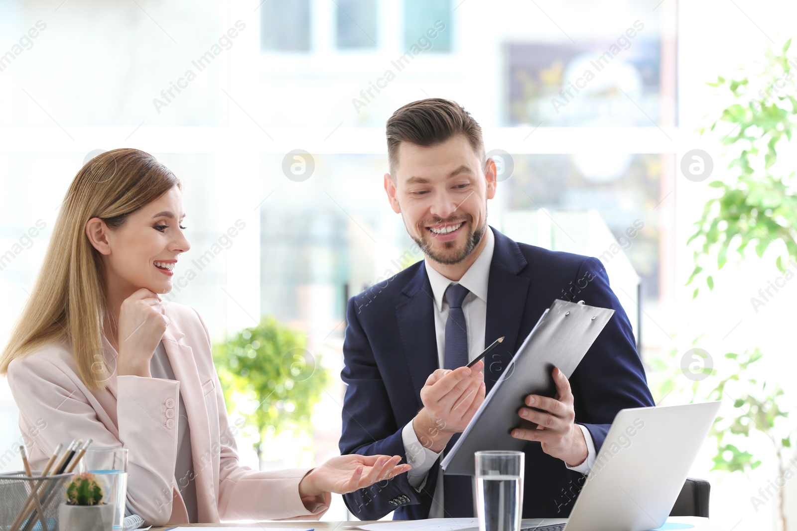 Photo of Young consultant working with client in office