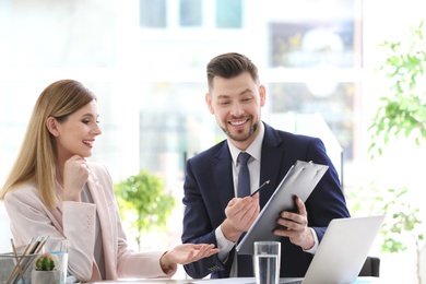 Young consultant working with client in office