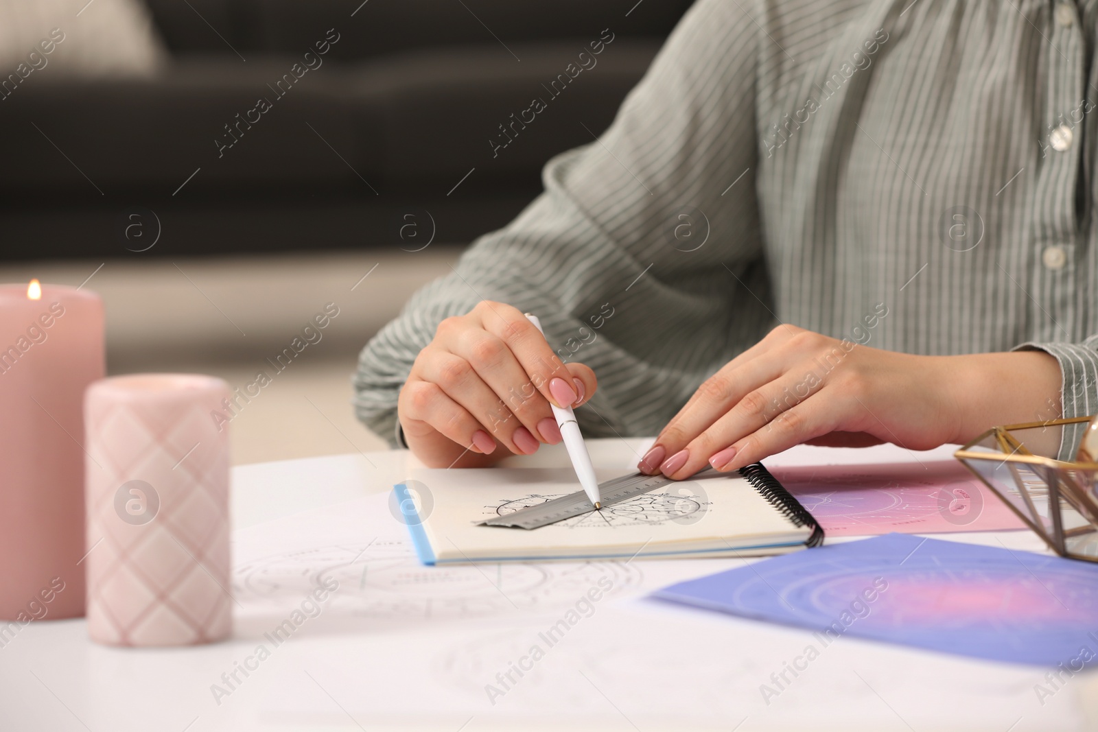 Photo of Astrologer using zodiac wheel for fate forecast at table, closeup. Fortune telling