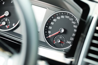 Speedometer and tachometer on modern car dashboard