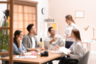 Blurred view of professional interior designers working in office