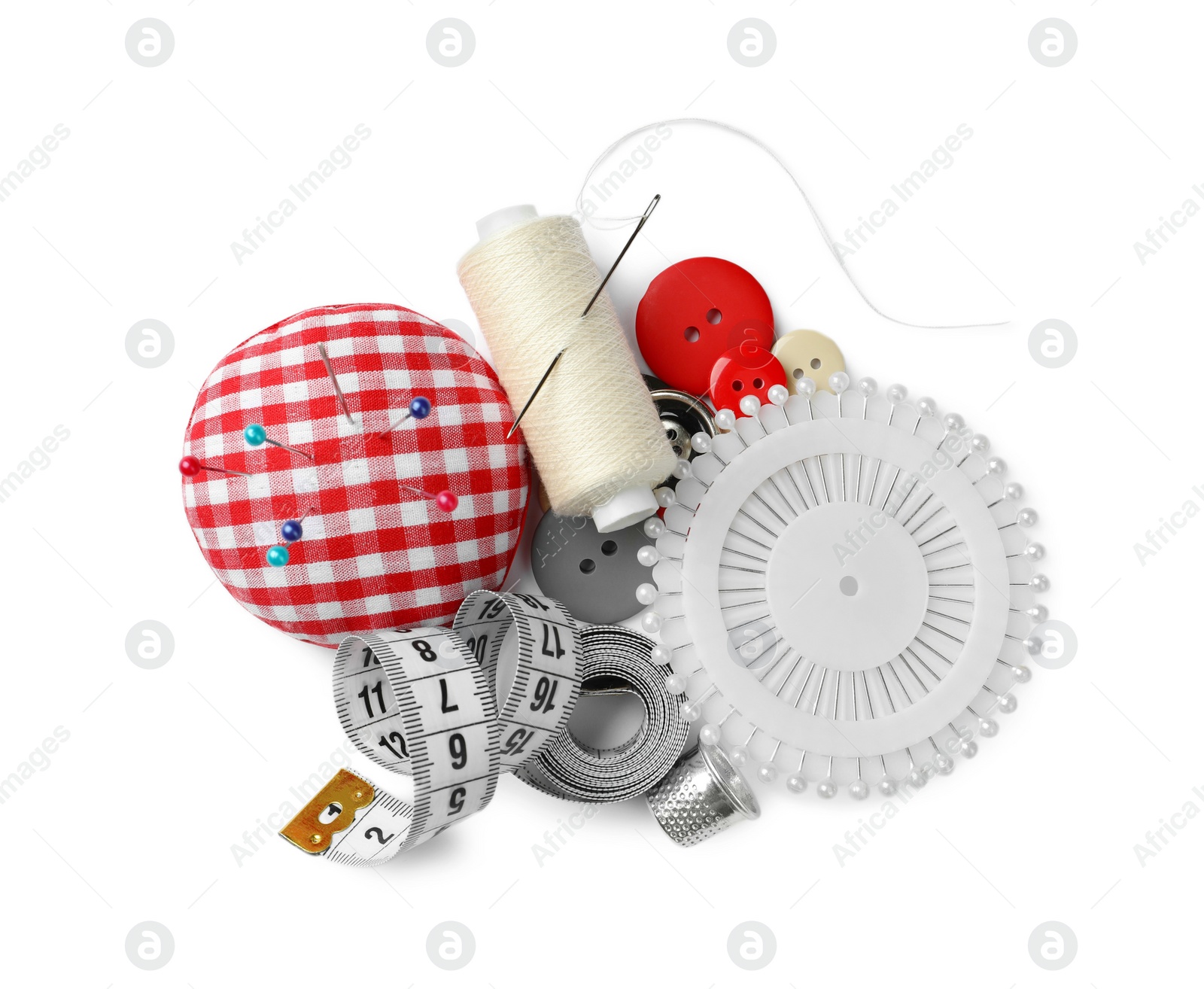 Photo of Spool of thread and sewing tools on white background, top view