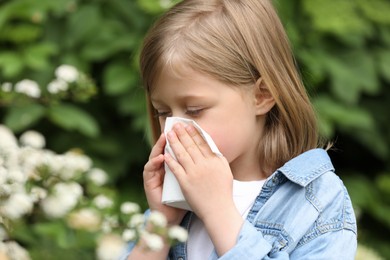 Little girl suffering from seasonal spring allergy outdoors