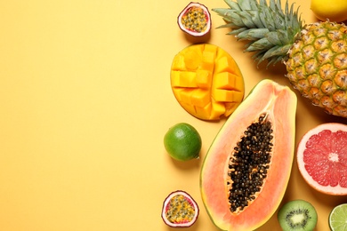 Photo of Fresh ripe papaya and other fruits on yellow background. flat lay. Space for text