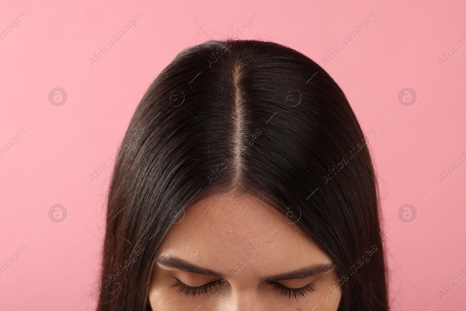 Photo of Woman with healthy hair on pink background, closeup