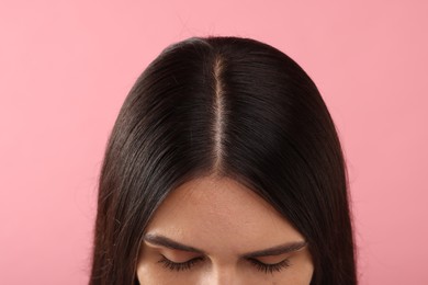 Photo of Woman with healthy hair on pink background, closeup