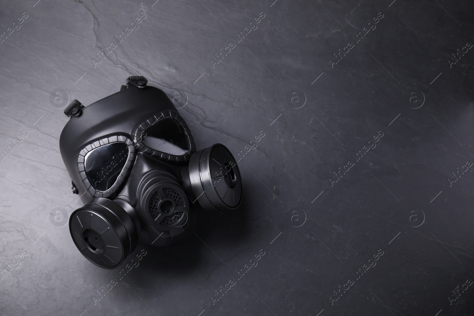 Photo of One gas mask on grey textured background, top view. Space for text