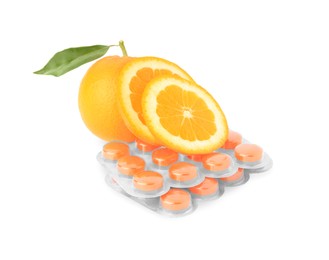 Photo of Fresh oranges and blisters with cough drops isolated on white
