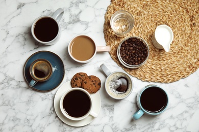 Photo of Flat lay composition with cups of coffee on marble background. Food photography
