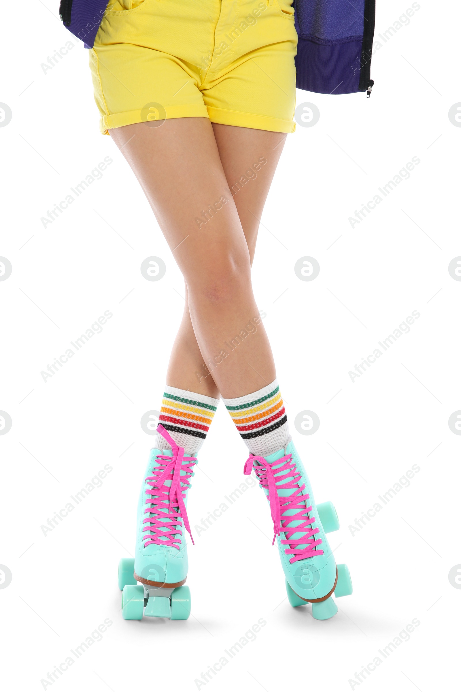 Photo of Young woman with vintage roller skates on white background, closeup view