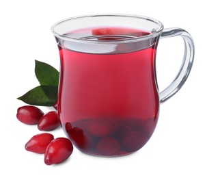 Glass cup of fresh dogwood tea, berries and leaves on white background