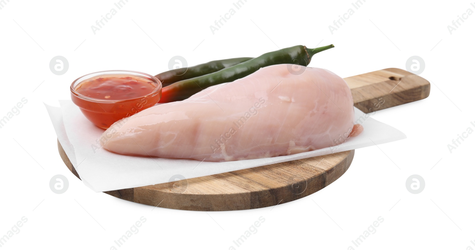 Photo of Marinade, basting brush, raw chicken fillets and chili peppers isolated on white