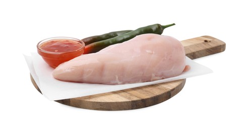 Photo of Marinade, basting brush, raw chicken fillets and chili peppers isolated on white