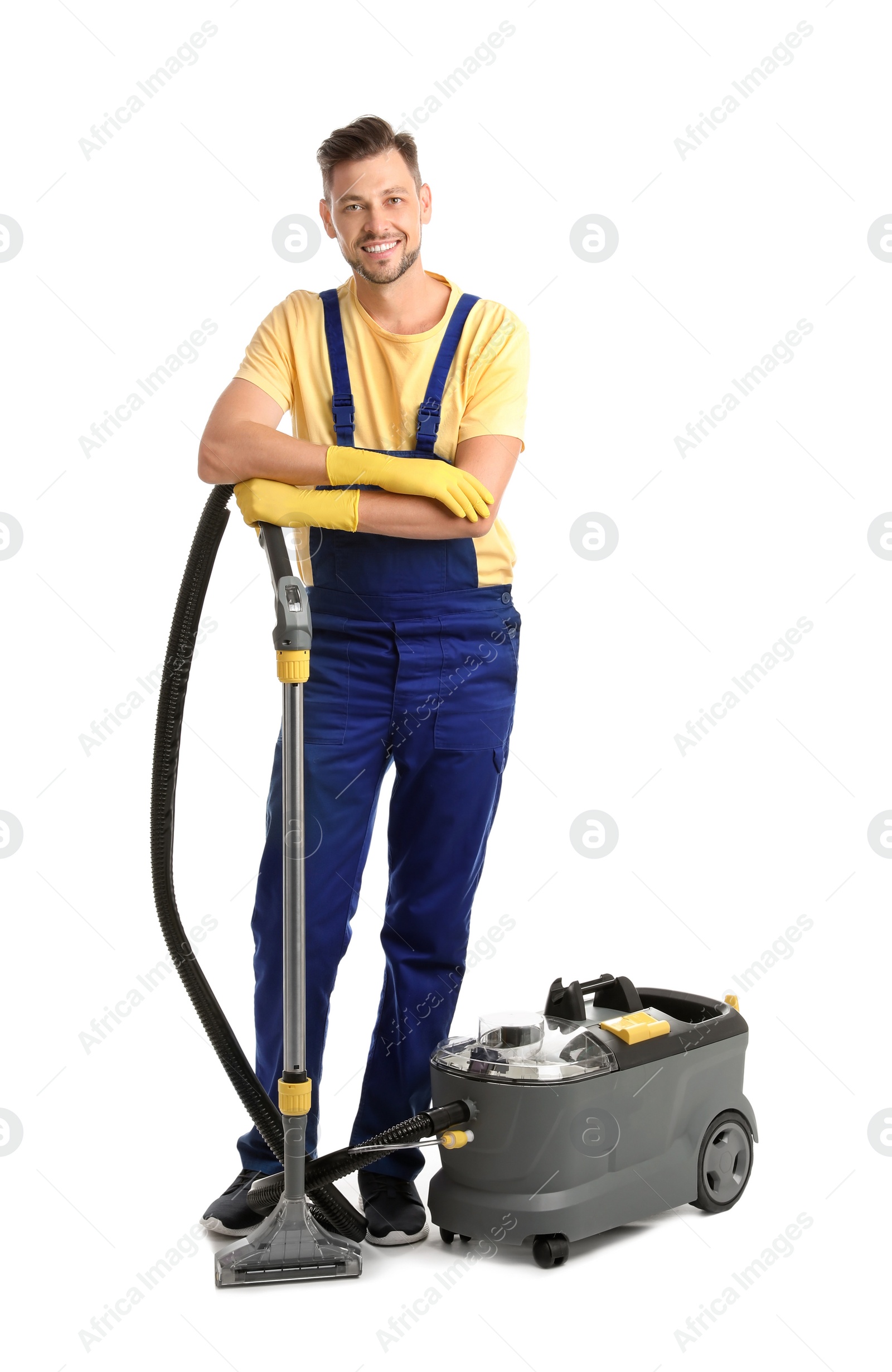 Photo of Male janitor with carpet cleaner on white background