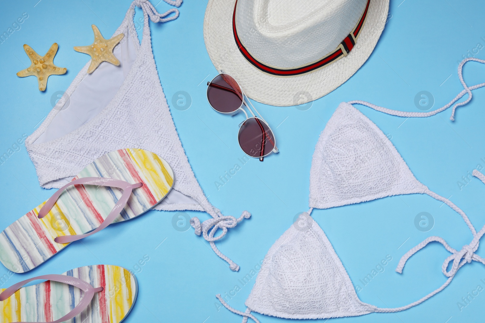 Photo of Flat lay composition with stylish bikini on color background. Beach objects