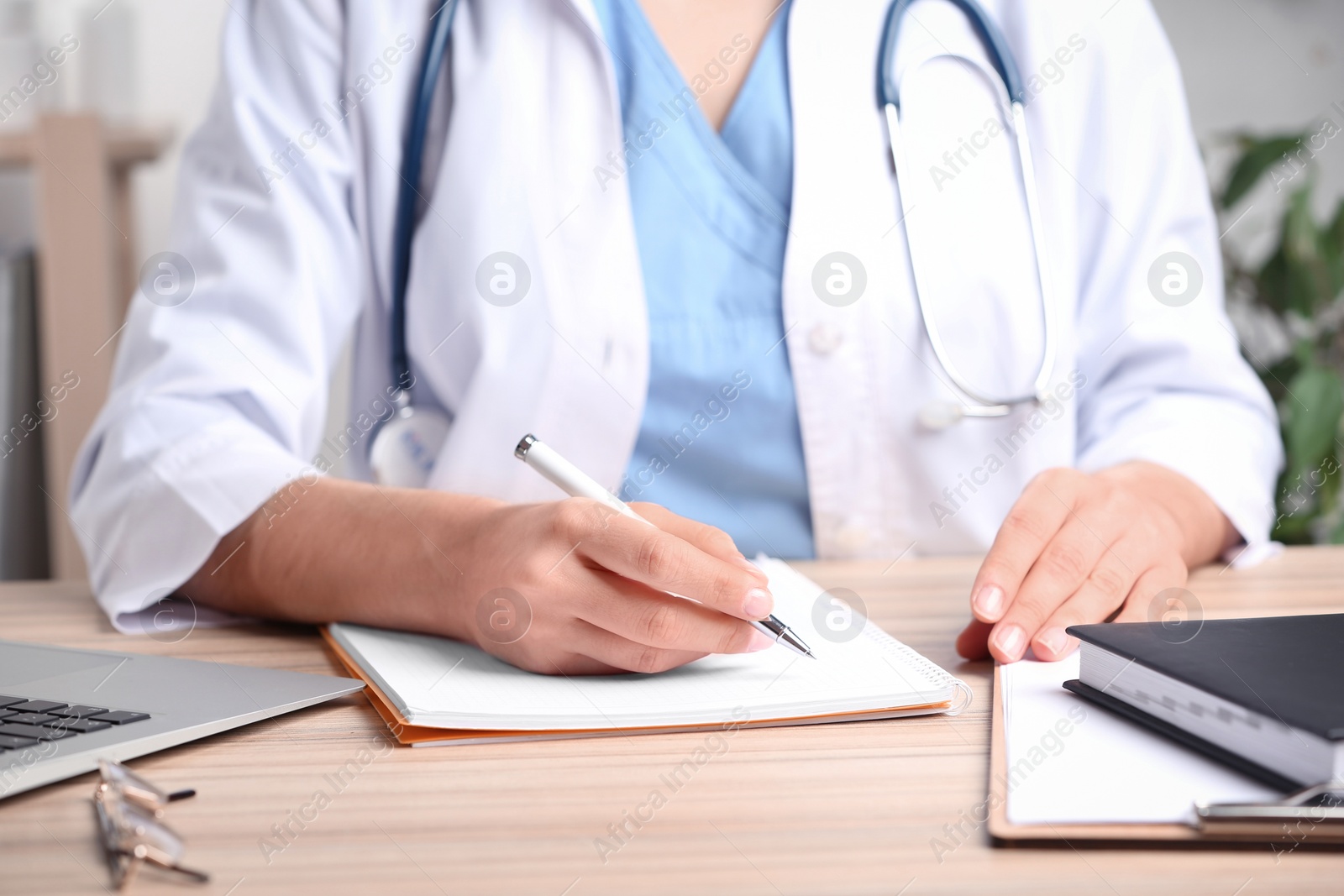 Photo of Doctor working at desk in office, closeup. Medical service