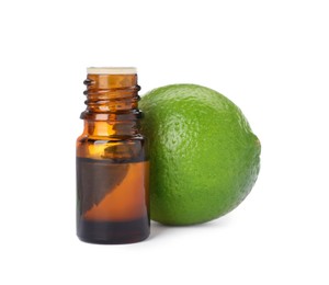Photo of Bottle of citrus essential oil and fresh lime isolated on white