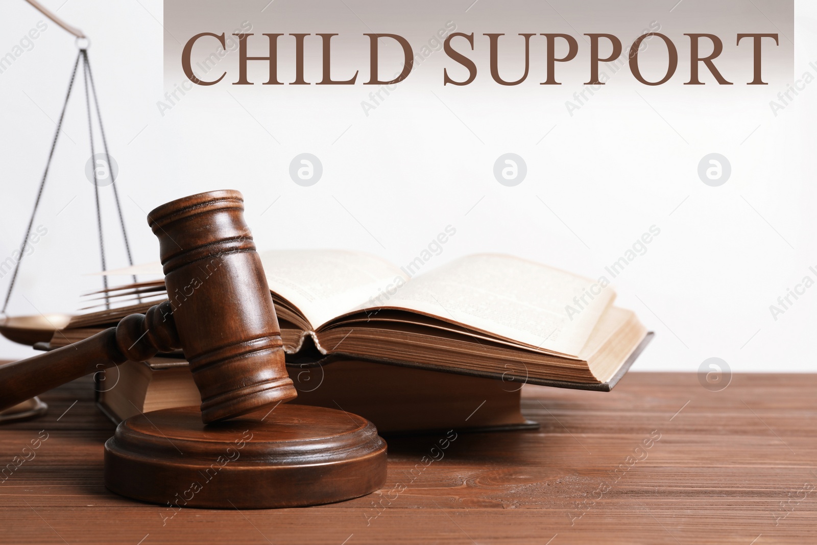 Image of Judge's gavel, scales of justice and books on wooden table. Child support concept